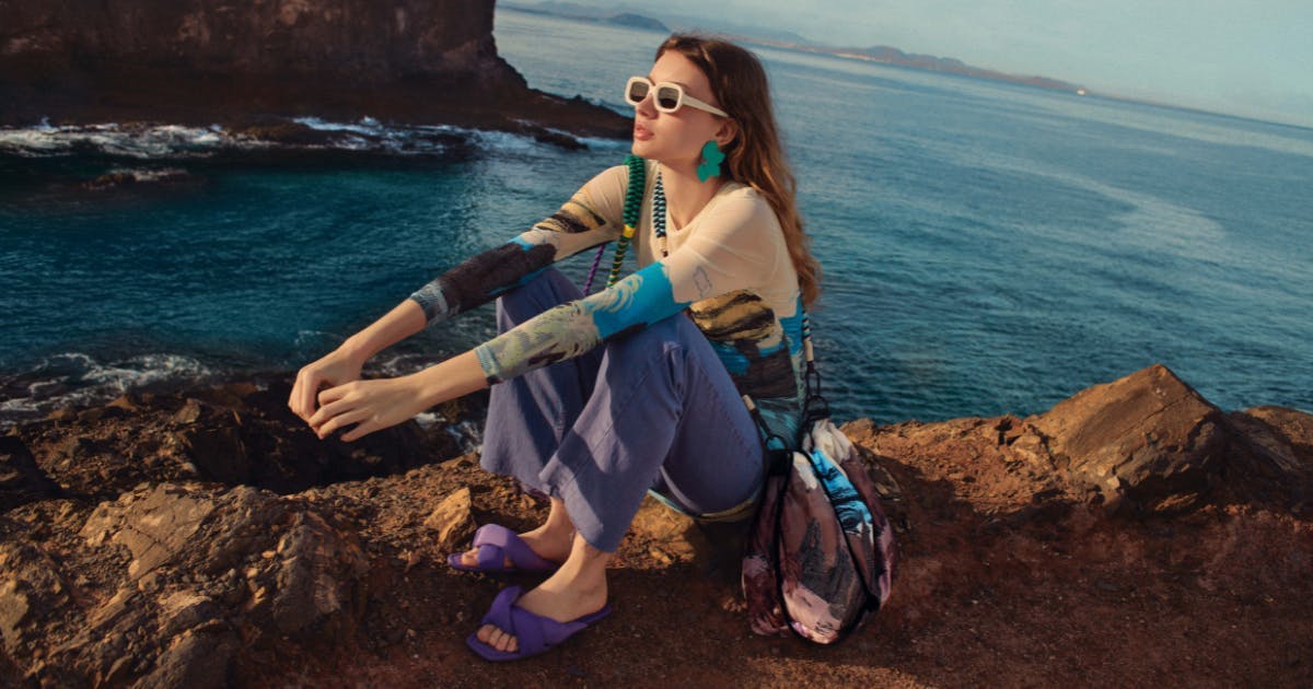 person clothing sunglasses accessories outdoors sea nature land shoreline soil