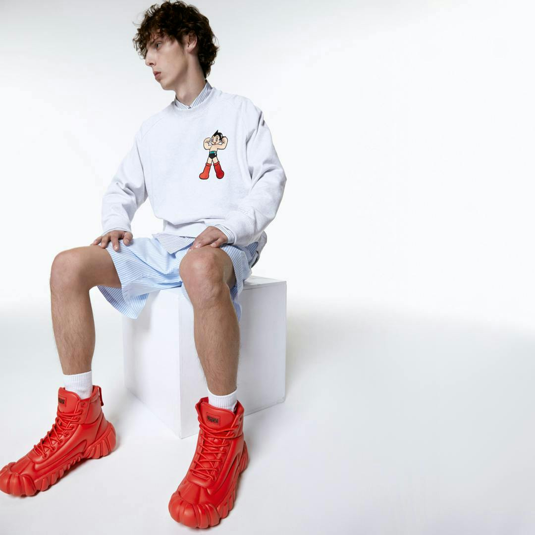 clothing footwear shoe person sitting sneaker boy male teen shorts