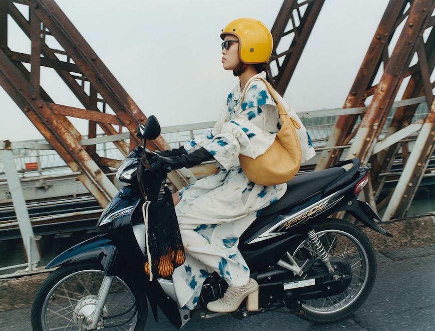 hardhat helmet adult female person woman wheel sitting motorcycle worker