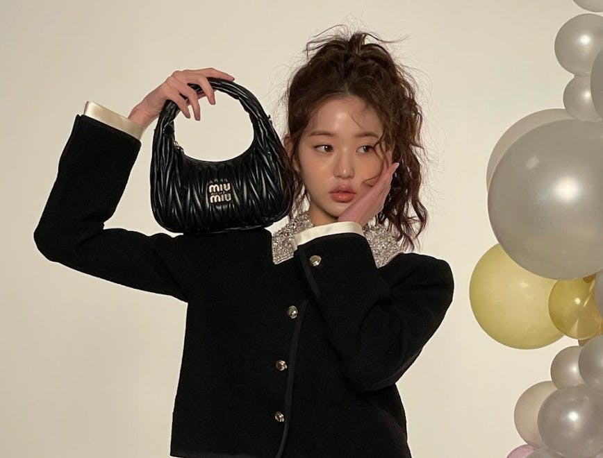 adult female person woman balloon face head bag handbag hair