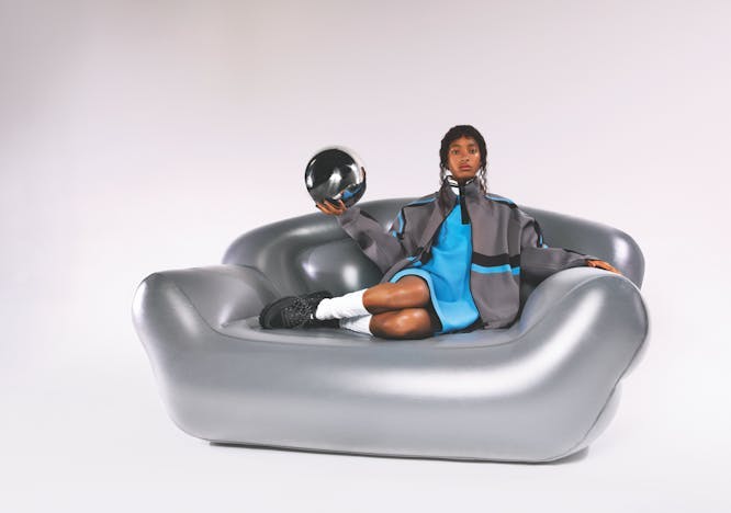 couch furniture person human helmet clothing apparel inflatable