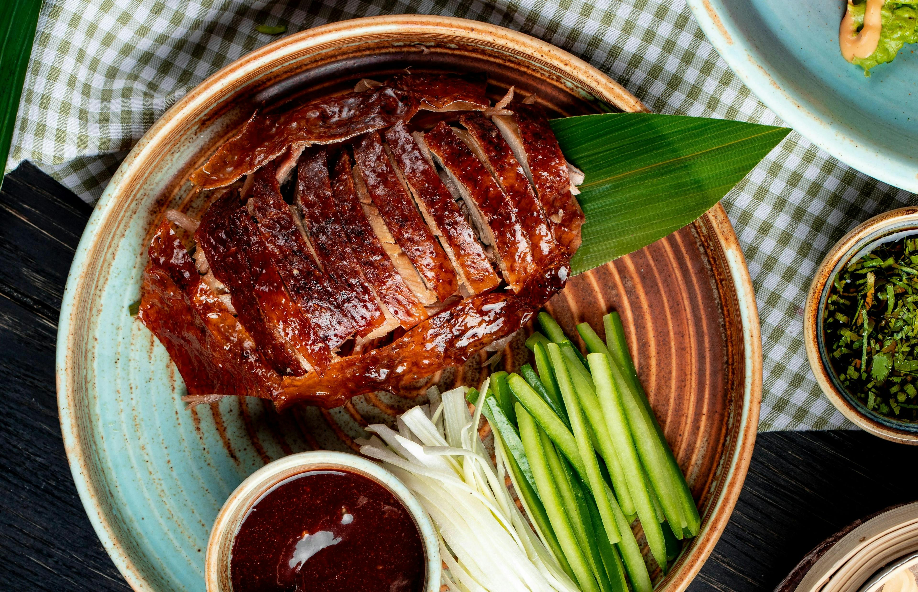top view traditional asian food peking duck cucumbers sauce plate roasted gourmet meat dish beijing china chinese meal roast cuisine dinner cooked grilled cooking asia service pork