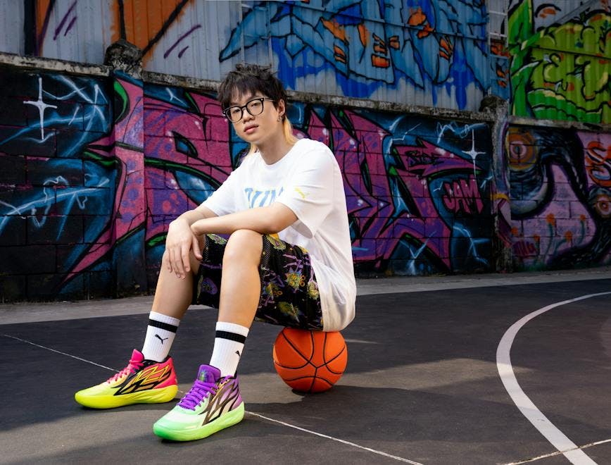 person sitting basketball (ball) sport footwear shoe sneaker accessories glasses playing basketball