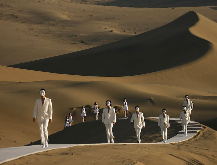dune nature outdoors sand desert person shoe walking coat face